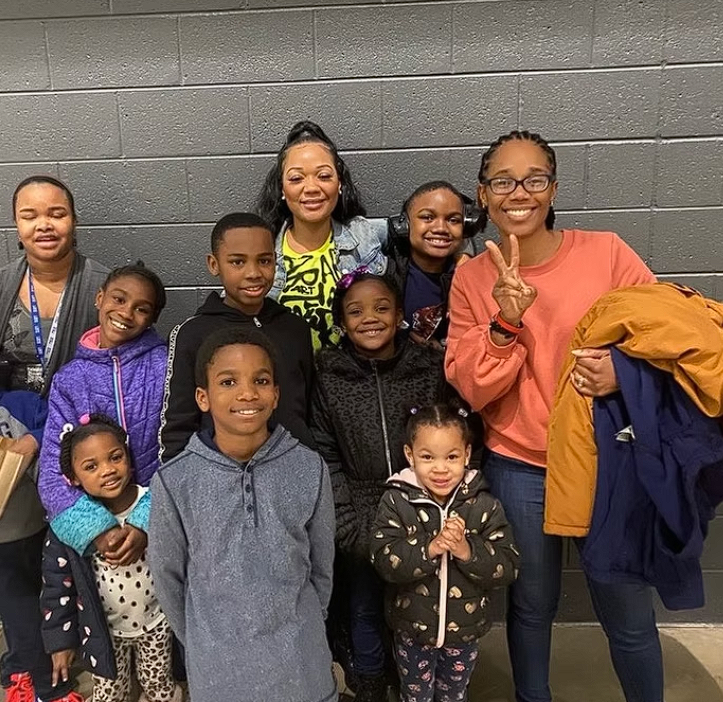 A smiling family group gathered together after an event