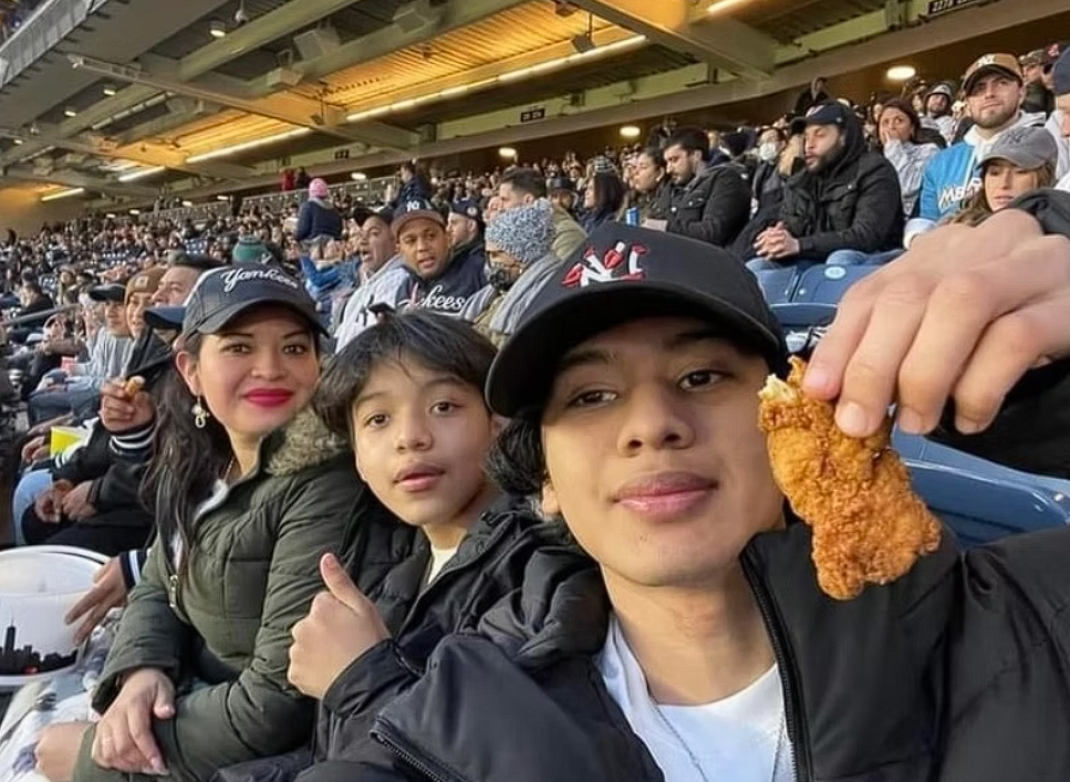 A family taking a selfie from baseball stadium seats