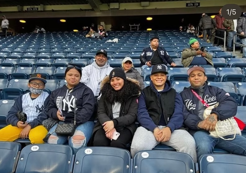 A family group sitting together in Yankee Stadium seats